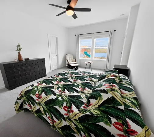 a bed sitting in a bedroom next to a window