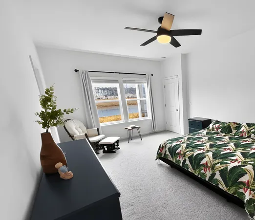 a bedroom with bed couch and window