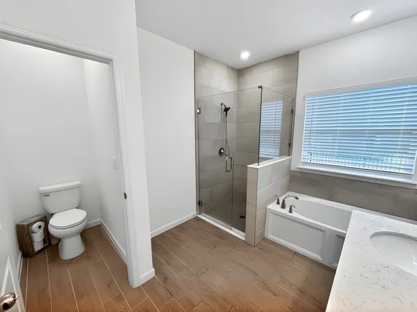 a bathroom with a toilet and a shower