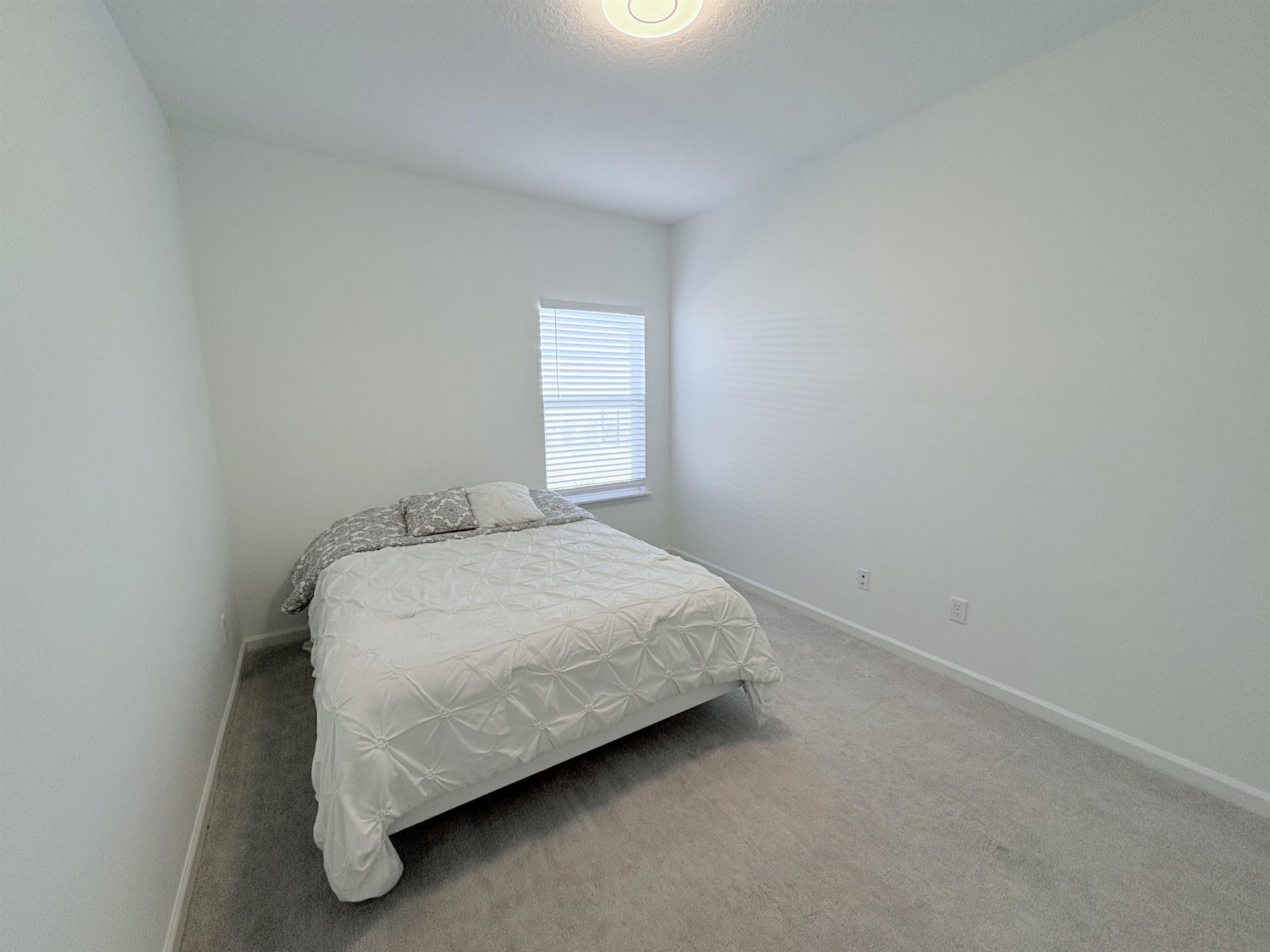 63 Quicksilver Way St. Augustine, FL 32092 - Photo 10 of 36 Bedroom with carpet flooring and baseboards