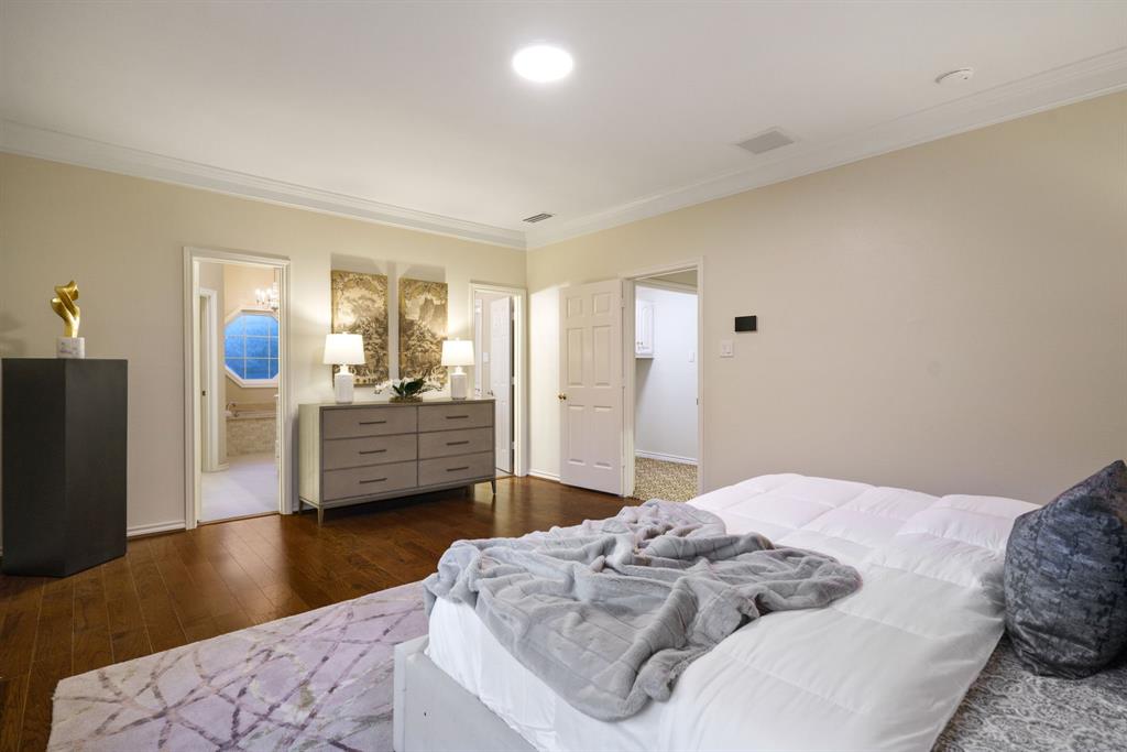7104 Judi Court Dallas, TX 75252 - Photo 27 of 40 a bedroom with a bed and wooden floor