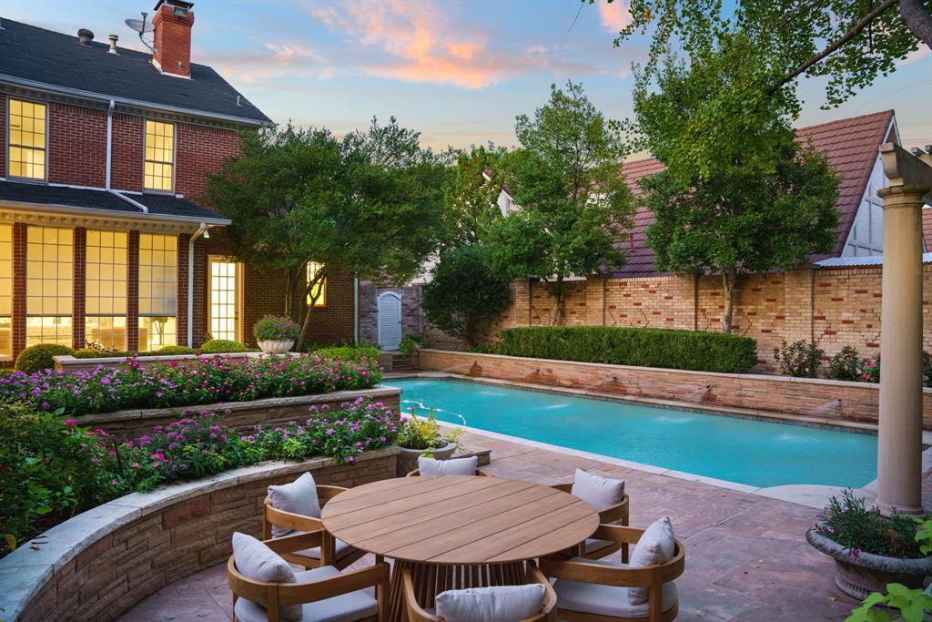 7104 Judi Court Dallas, TX 75252 - Photo 3 of 40 a view of a chair and table on the garden