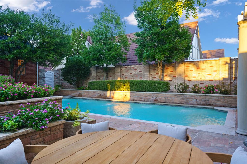 7104 Judi Court Dallas, TX 75252 - Photo 6 of 40 a view of a swimming pool with a patio