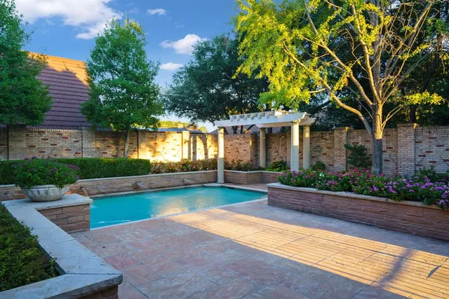 a view of a house with swimming pool and a yard