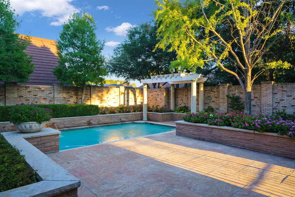 7104 Judi Court Dallas, TX 75252 - Photo 8 of 40 a view of a house with swimming pool and a yard