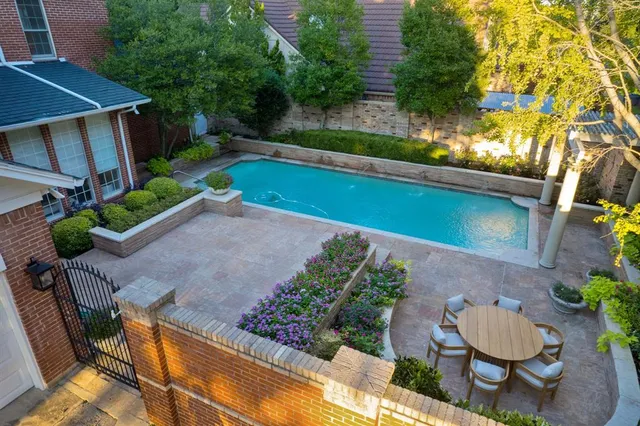 a view of a backyard with plants and a garden