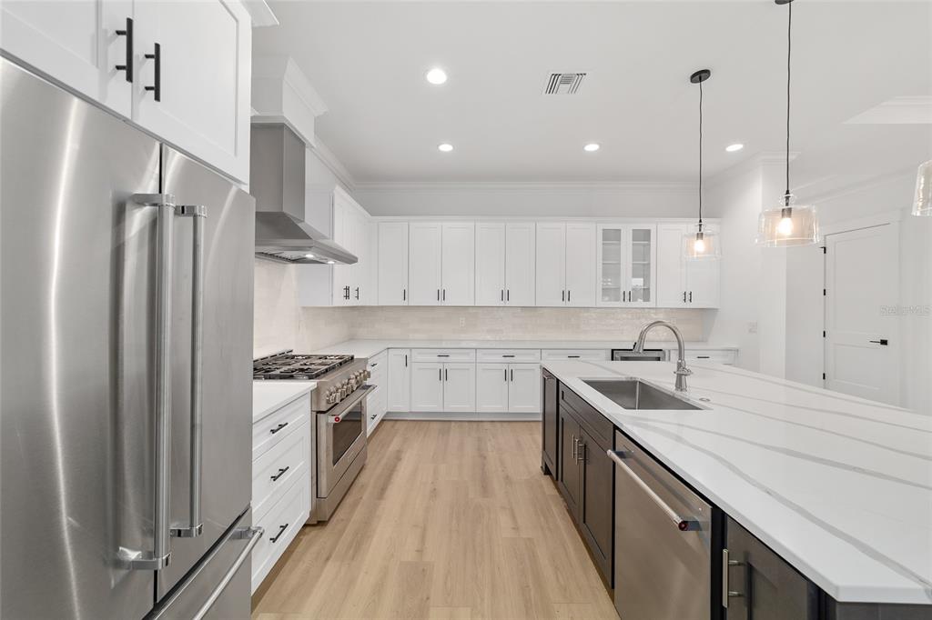 5775 Southwest 43rd Place Ocala, FL 34474 - Photo 18 of 52 a kitchen with a sink a counter top space stainless steel appliances and cabinets