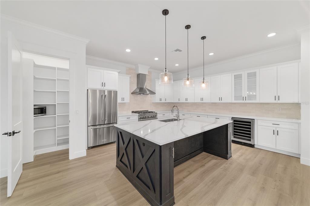 5775 Southwest 43rd Place Ocala, FL 34474 - Photo 19 of 52 a kitchen with a sink a center island stainless steel appliances and cabinets