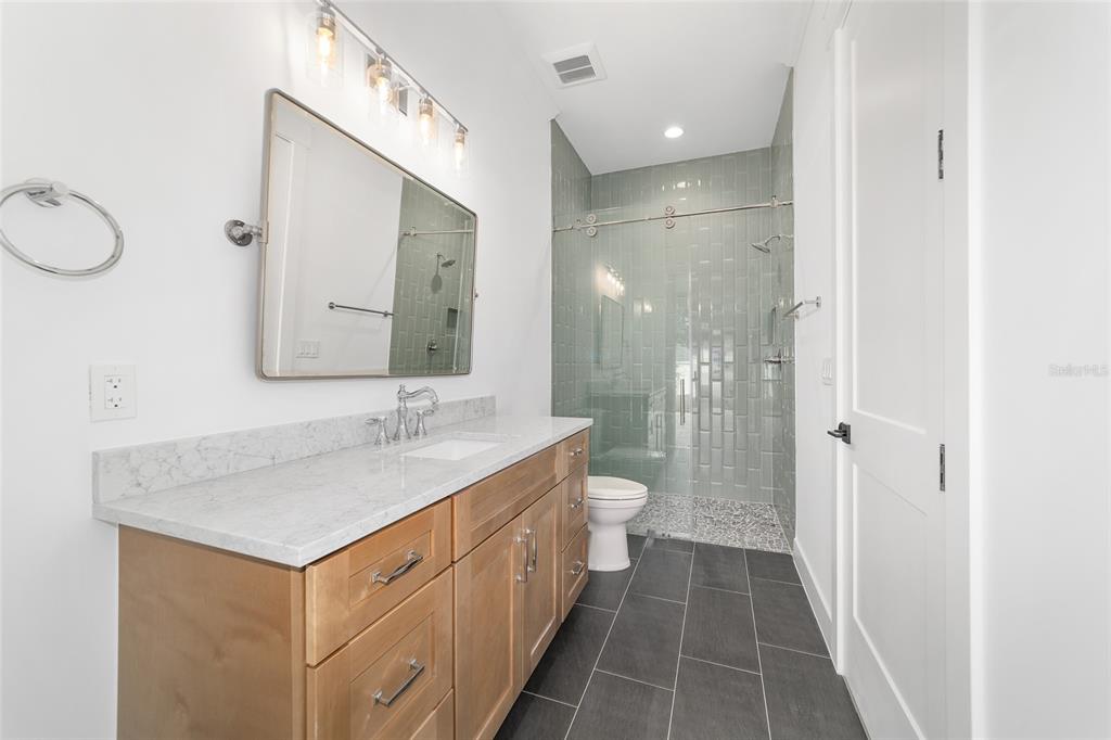 5775 Southwest 43rd Place Ocala, FL 34474 - Photo 33 of 52 a bathroom with a sink a toilet and a large mirror