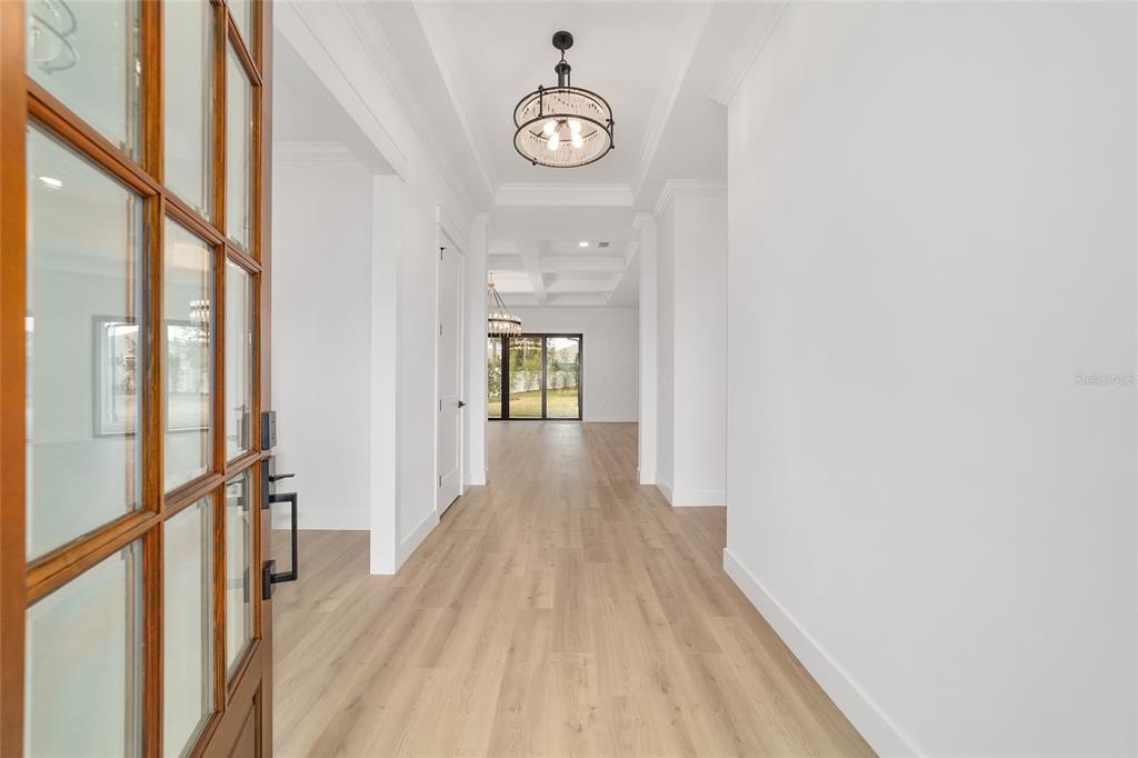 5775 Southwest 43rd Place Ocala, FL 34474 - Photo 4 of 52 a view of a hallway with wooden floor and a chandelier