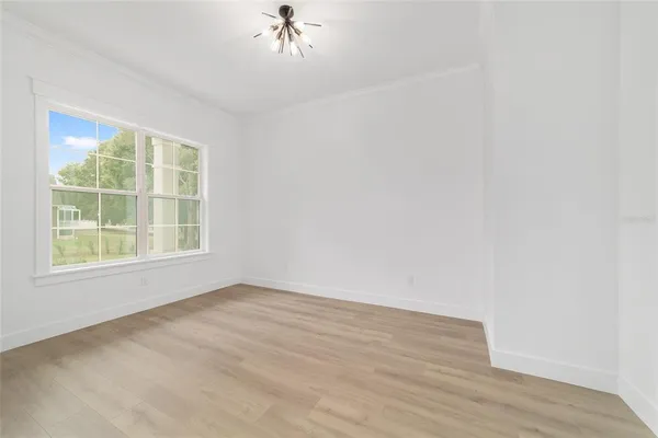 a kitchen with a sink a center island stainless steel appliances and cabinets