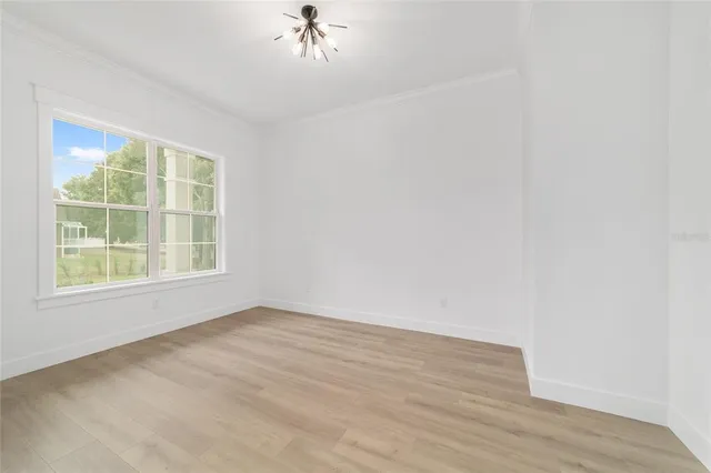 a kitchen with a sink a center island stainless steel appliances and cabinets