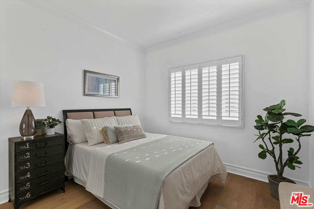 1710 Granville Avenue, Unit 3 Los Angeles, CA 90025 - Photo 18 of 21 a bedroom with a bed and a potted plant
