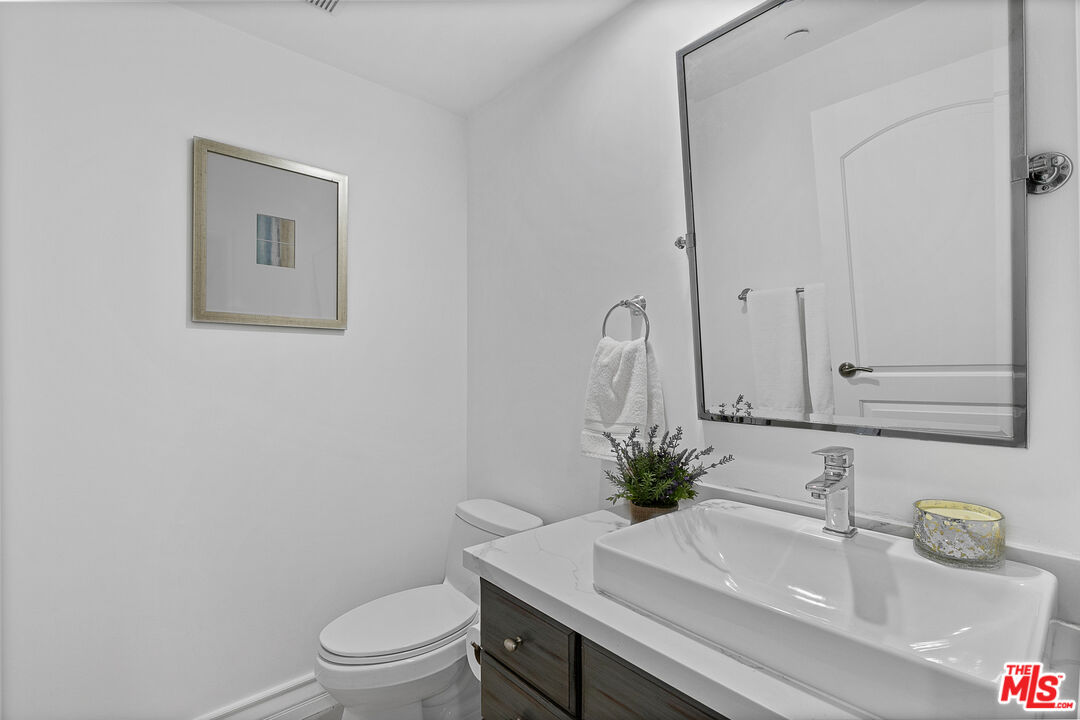 1710 Granville Avenue, Unit 3 Los Angeles, CA 90025 - Photo 19 of 21 a bathroom with a sink a toilet and a mirror