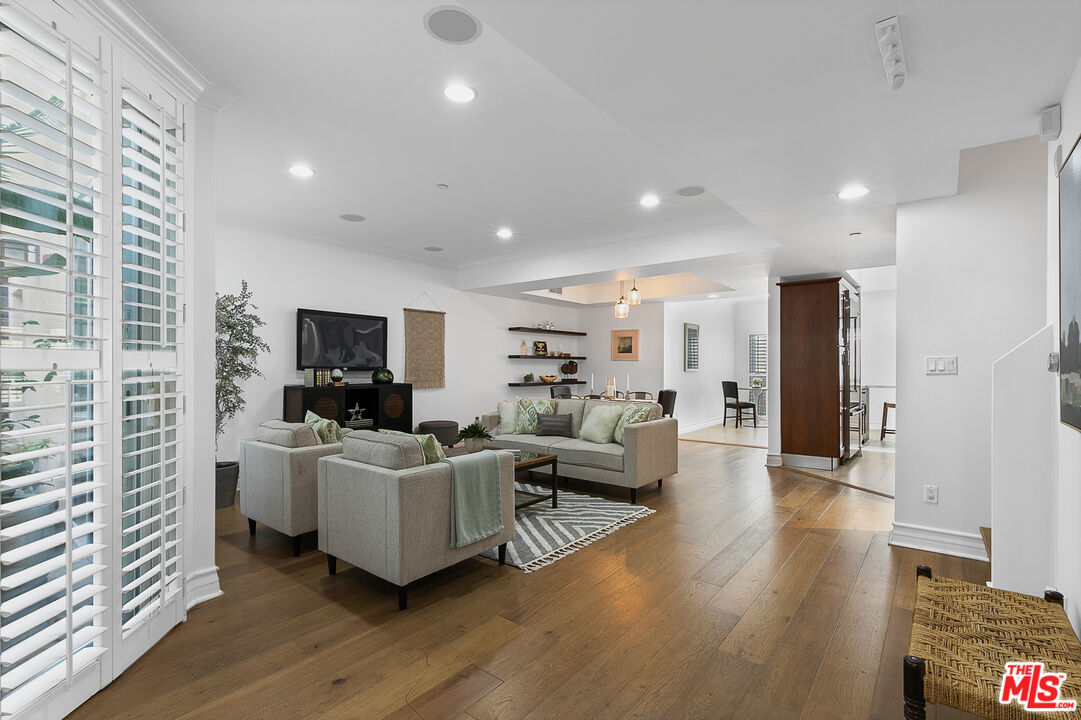 1710 Granville Avenue, Unit 3 Los Angeles, CA 90025 - Photo 3 of 21 a living room with furniture a flat screen tv and a wooden floor