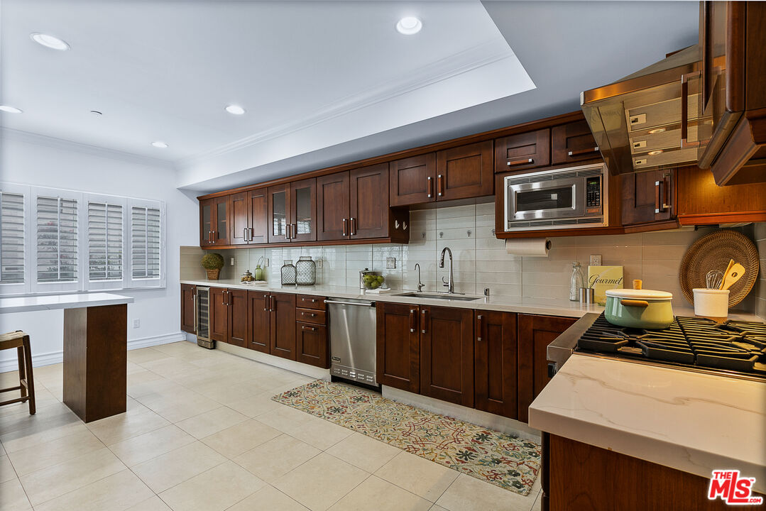 1710 Granville Avenue, Unit 3 Los Angeles, CA 90025 - Photo 7 of 21 a kitchen with stainless steel appliances granite countertop a stove sink and cabinets