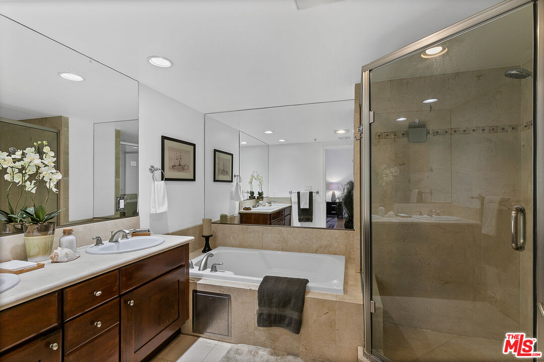 1710 Granville Avenue, Unit 3 Los Angeles, CA 90025 - Photo 10 of 21 a large bathroom with a double vanity sink a large mirror and shower