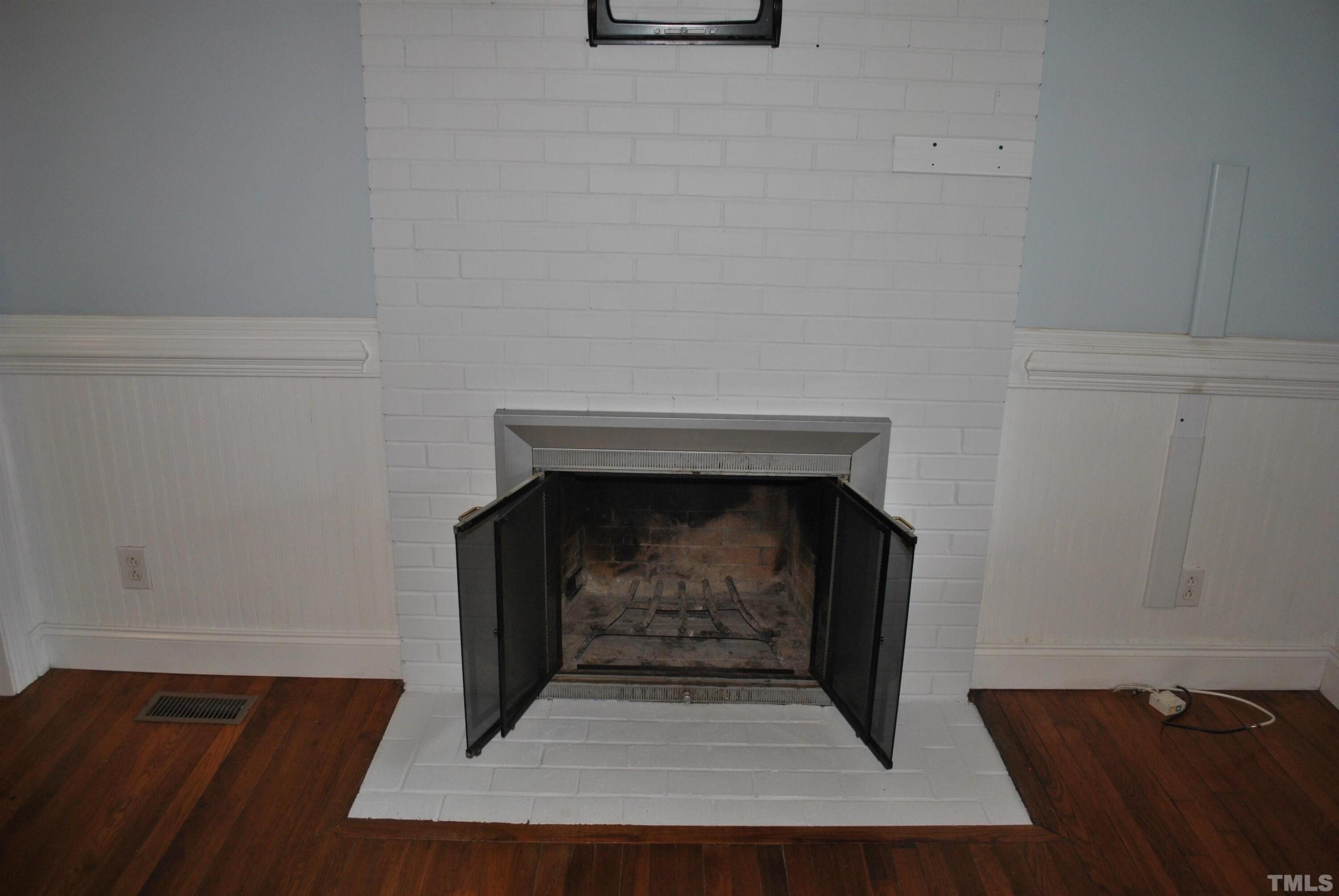 2106 Brewer Street Raleigh, NC 27608 - Photo 12 of 38 a living room with a fireplace