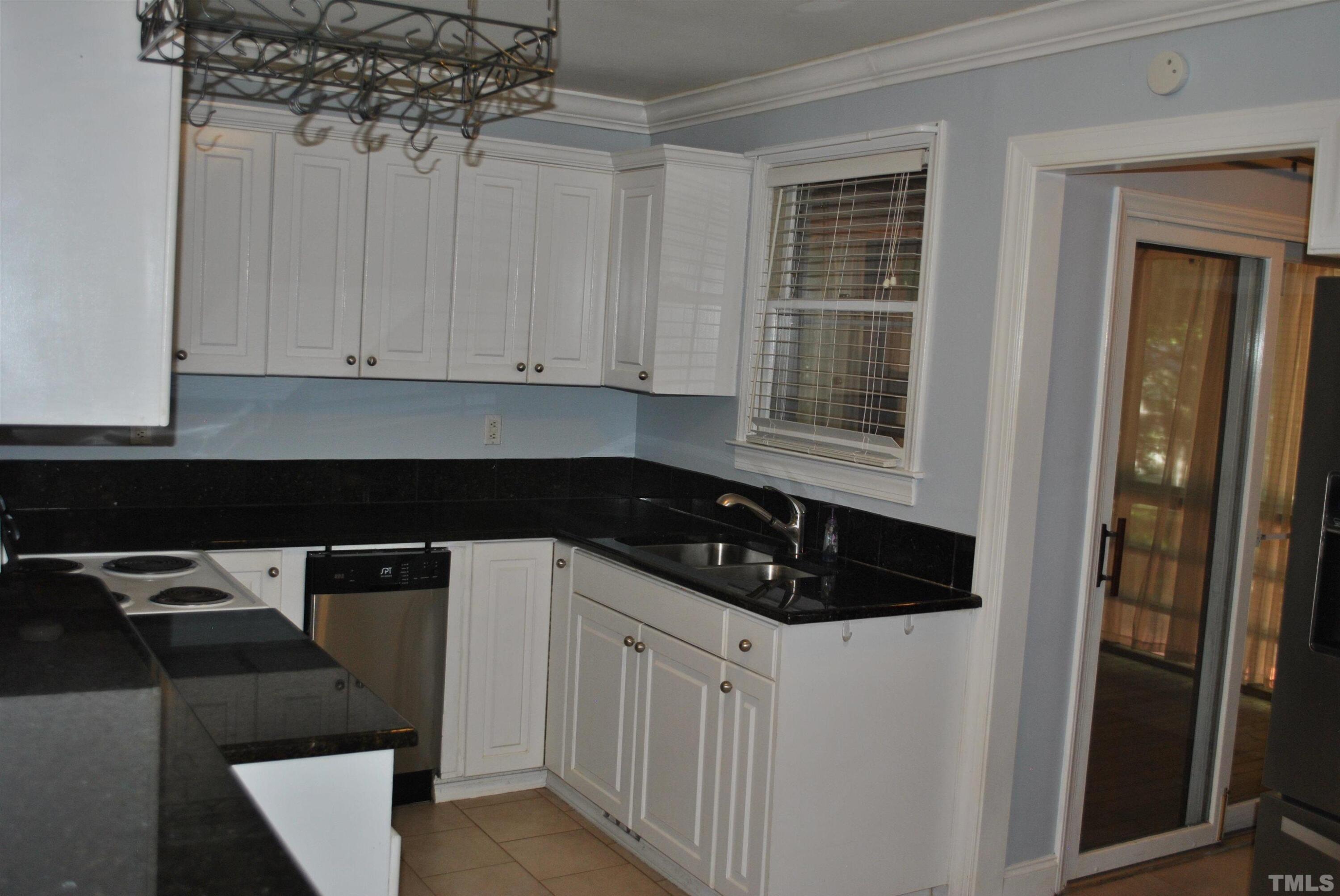 2106 Brewer Street Raleigh, NC 27608 - Photo 13 of 38 a kitchen with a sink and cabinets