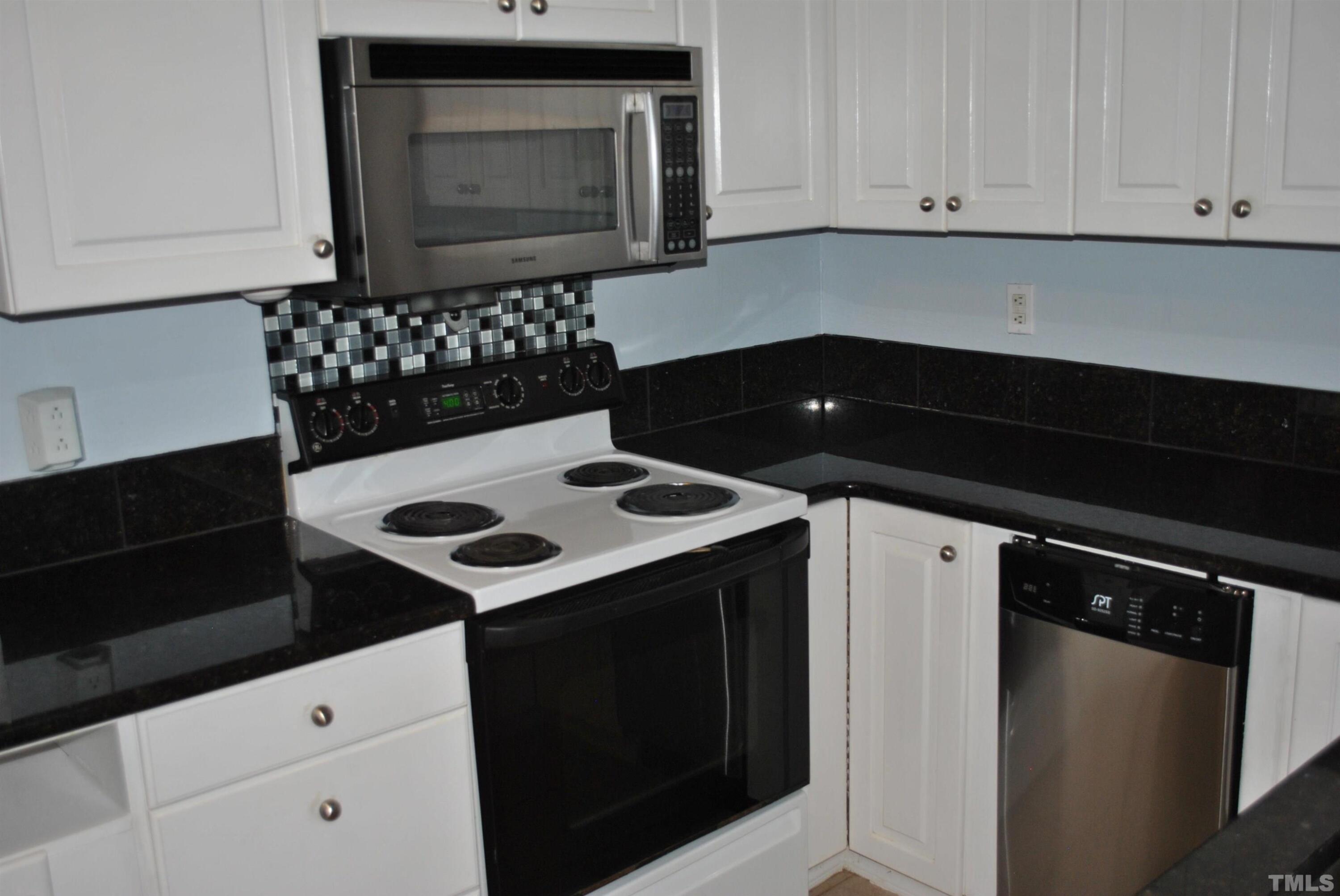 2106 Brewer Street Raleigh, NC 27608 - Photo 16 of 38 a kitchen with a stove and a microwave