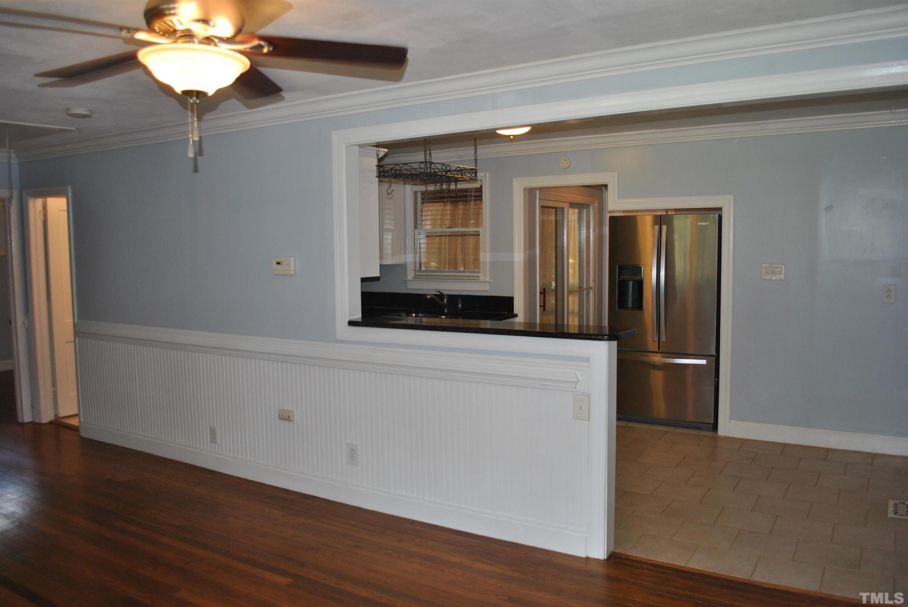 2106 Brewer Street Raleigh, NC 27608 - Photo 21 of 38 a hallway with wooden floor and chandelier