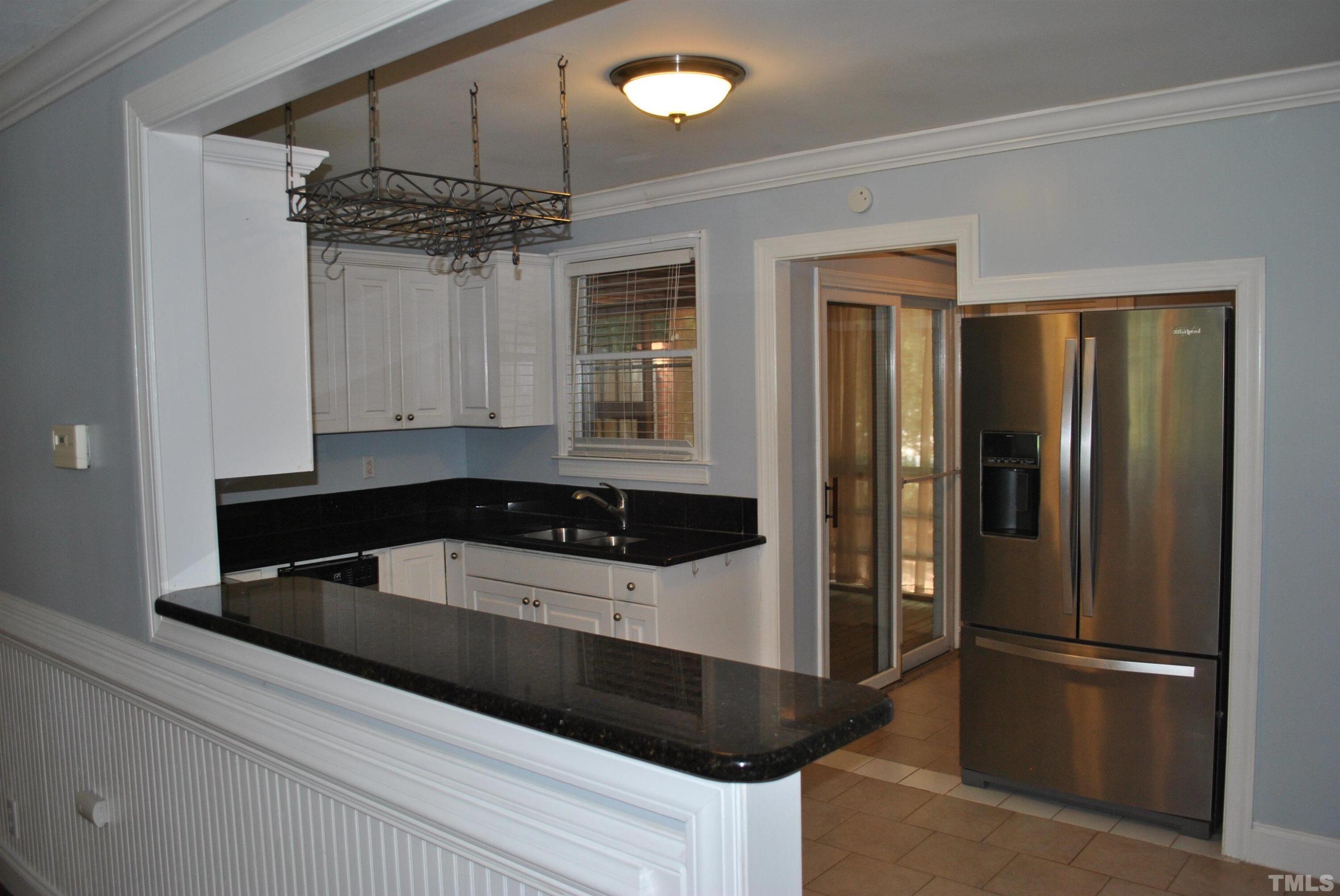 2106 Brewer Street Raleigh, NC 27608 - Photo 26 of 38 a kitchen with a refrigerator and a sink