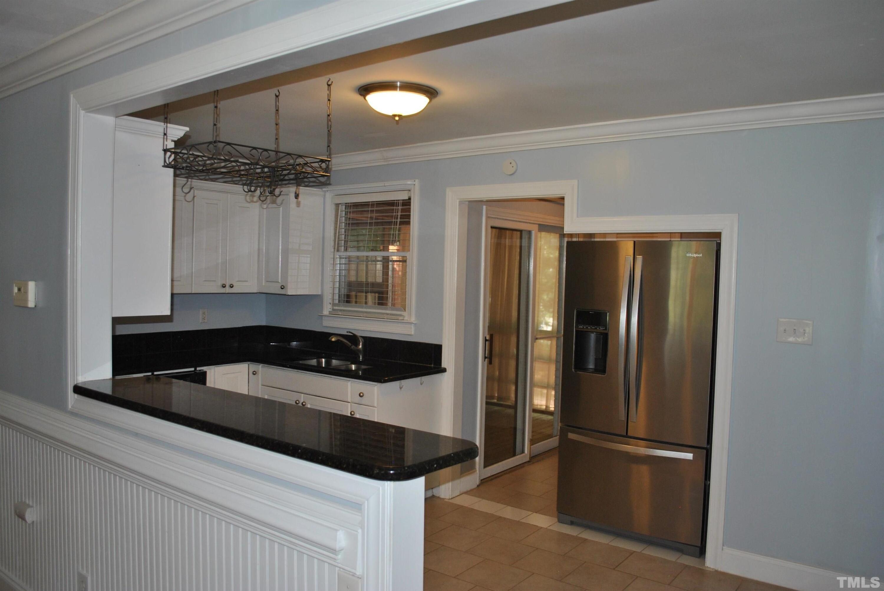 2106 Brewer Street Raleigh, NC 27608 - Photo 27 of 38 a kitchen with a refrigerator and a sink
