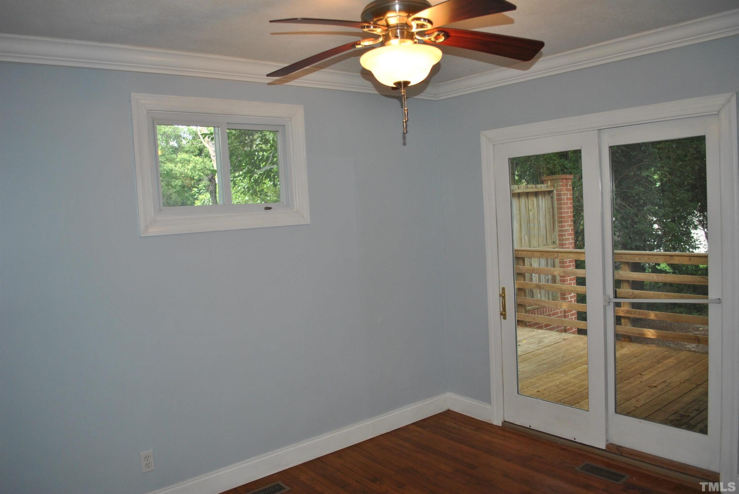 2106 Brewer Street Raleigh, NC 27608 - Photo 29 of 38 an empty room with wooden floor fan and windows