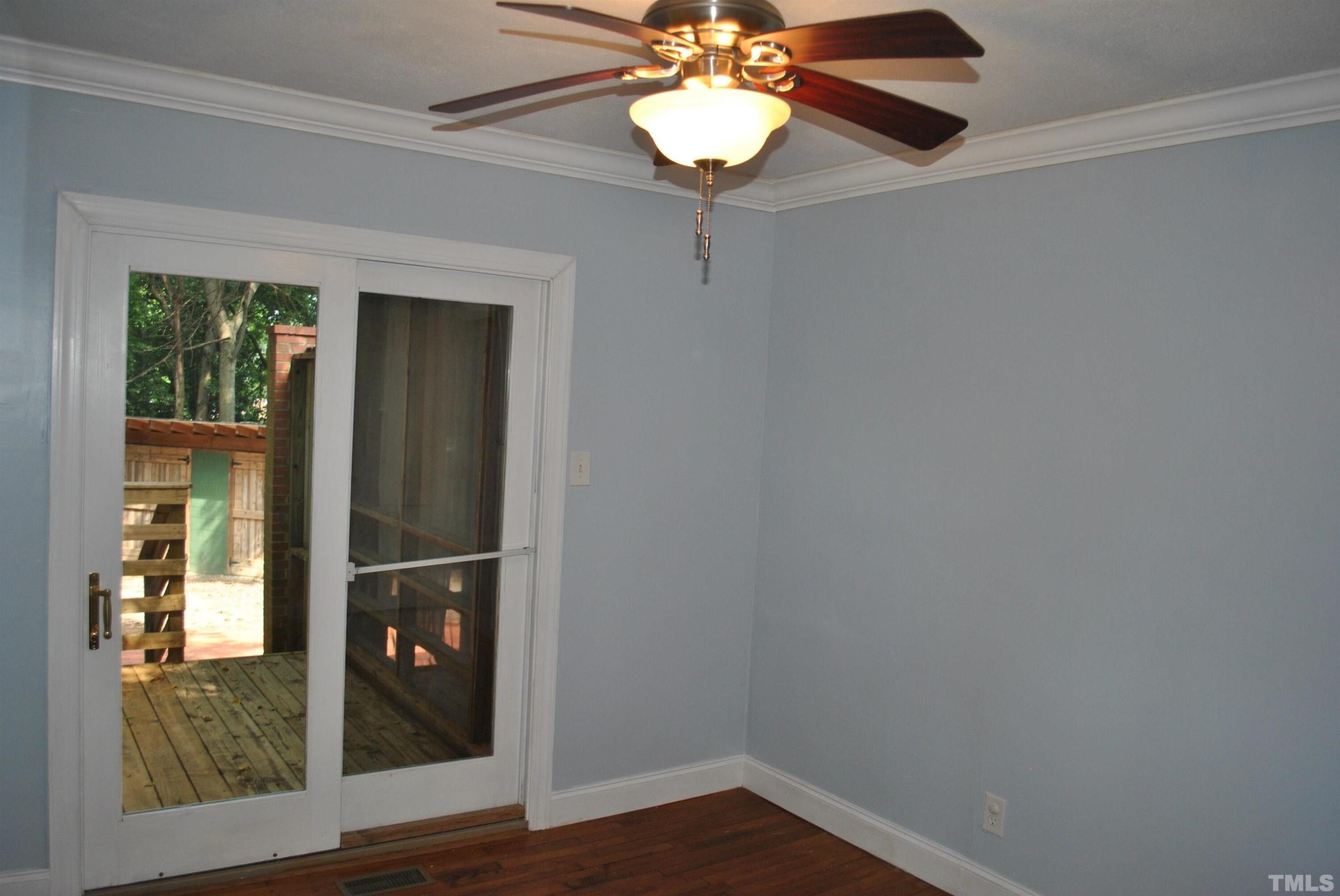 2106 Brewer Street Raleigh, NC 27608 - Photo 30 of 38 a view of a livingroom with a chandelier fan and wooden floor