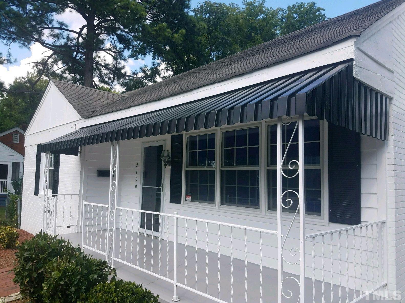 2106 Brewer Street Raleigh, NC 27608 - Photo 38 of 38 a view of a house with a large window and wooden fence