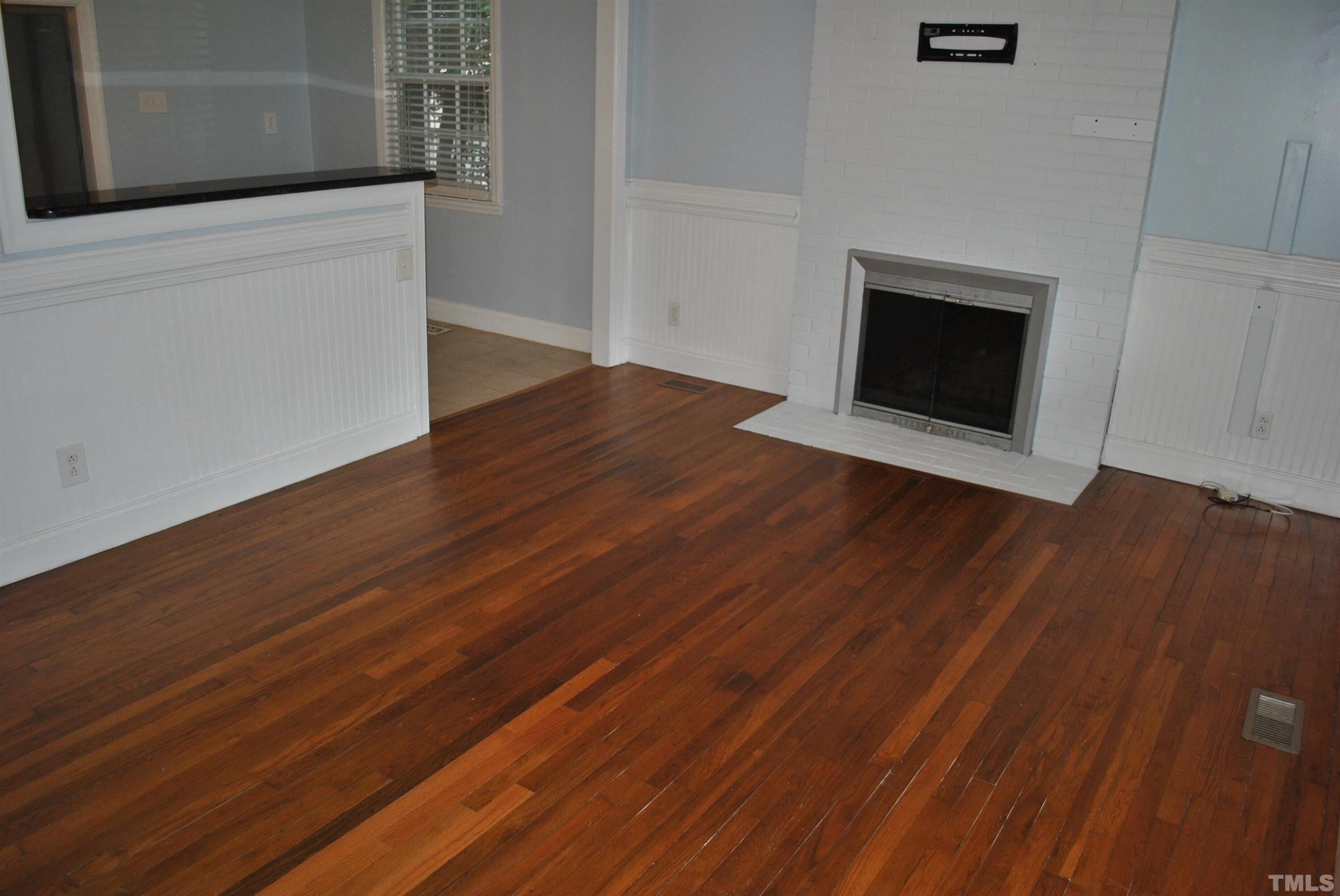2106 Brewer Street Raleigh, NC 27608 - Photo 6 of 38 a view of an empty room with wooden floor and a window