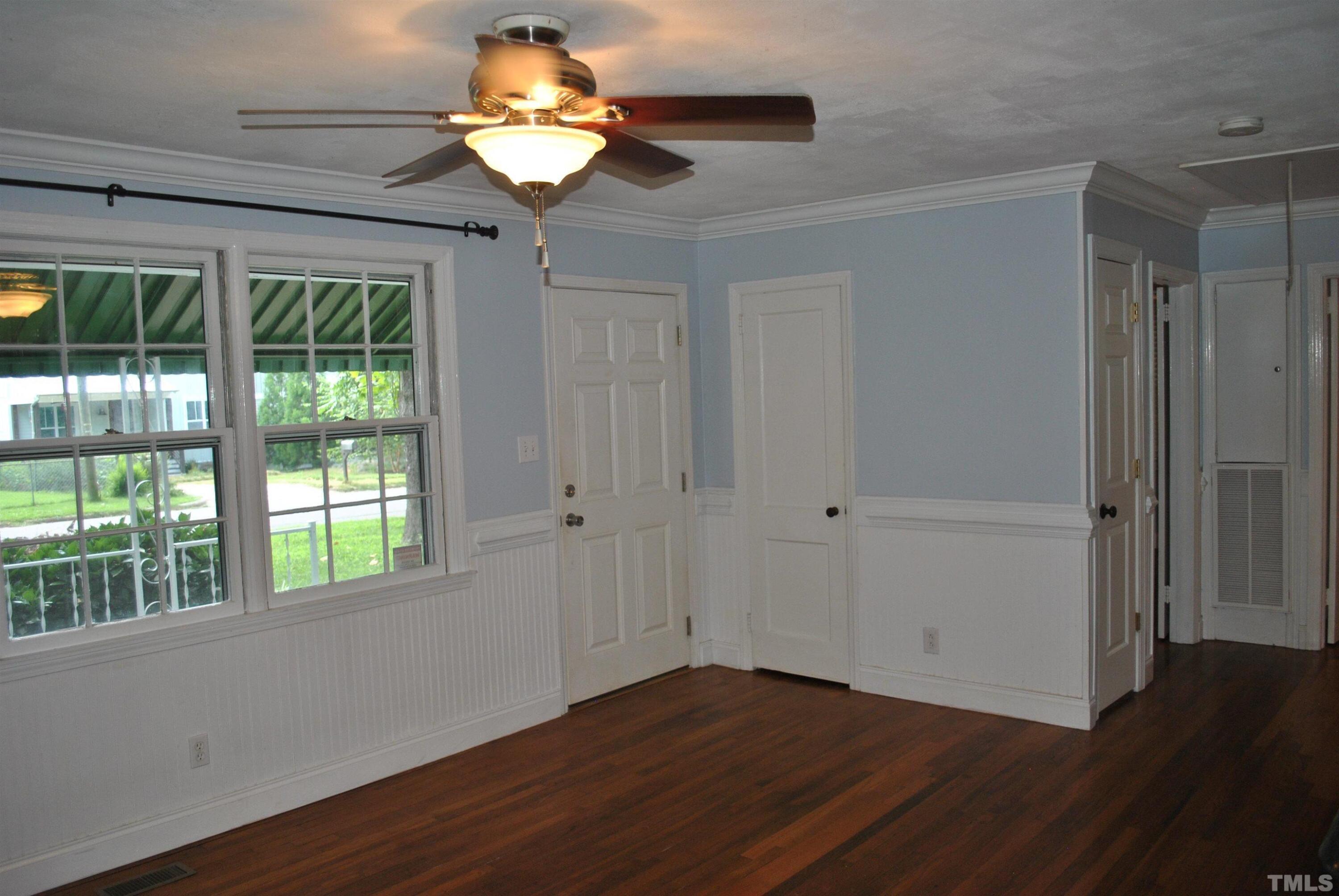 2106 Brewer Street Raleigh, NC 27608 - Photo 8 of 38 a view of an empty room with wooden floor and a window