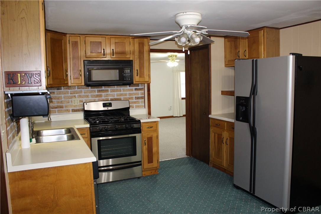 1174 North River Road Bohannon, VA 23021 - Photo 12 of 35 a kitchen with a refrigerator stove and microwave
