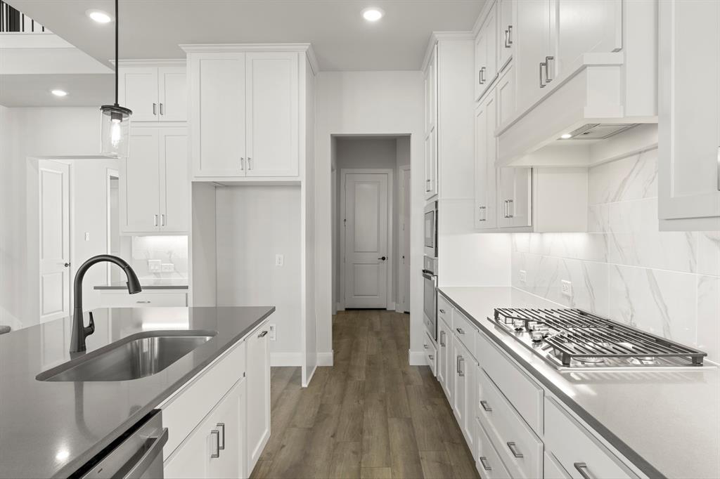 912 Firewood Way Anna, TX 75409 - Photo 11 of 29 a kitchen with kitchen island a sink stove and refrigerator