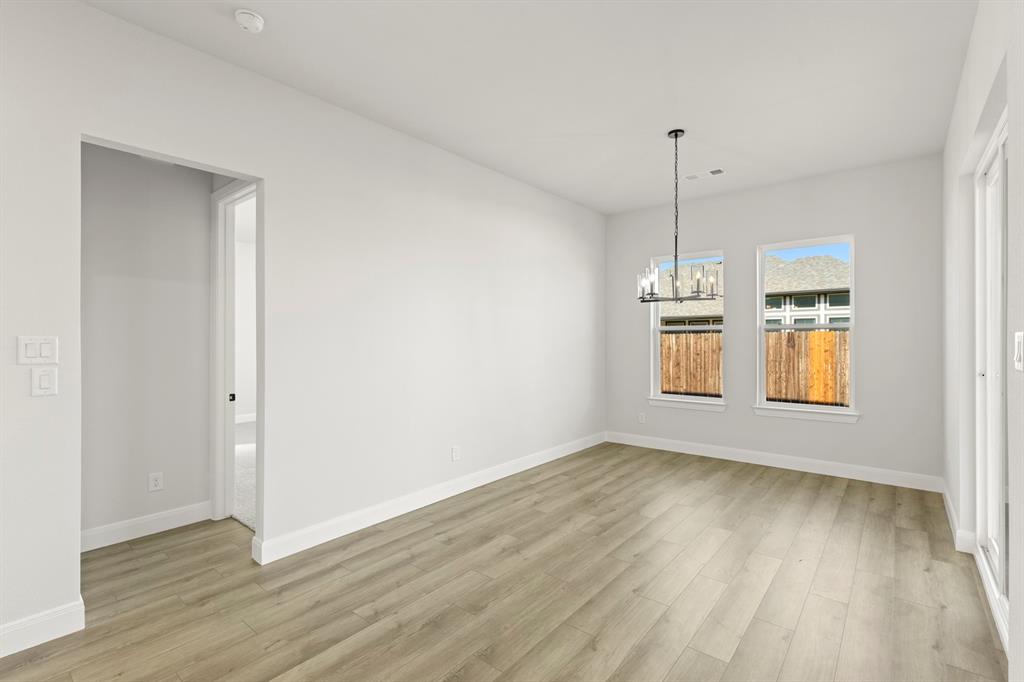 912 Firewood Way Anna, TX 75409 - Photo 13 of 29 a view of an empty room with window and wooden floor