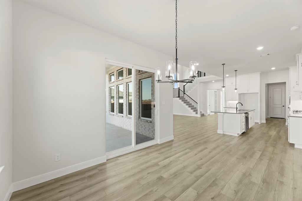 912 Firewood Way Anna, TX 75409 - Photo 14 of 29 a view of a kitchen with wooden floor and staircase