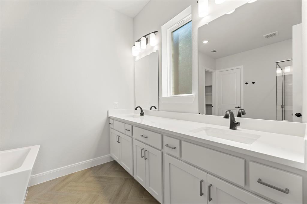 912 Firewood Way Anna, TX 75409 - Photo 16 of 29 a bathroom with a double vanity sink and mirror
