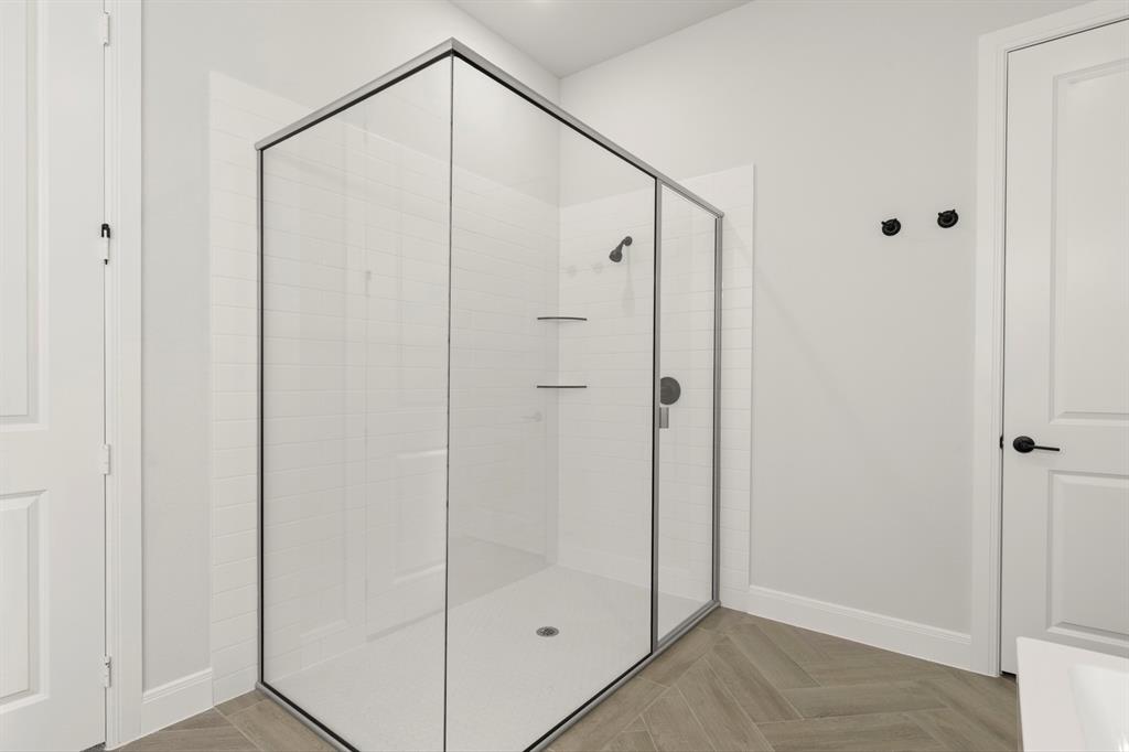 912 Firewood Way Anna, TX 75409 - Photo 18 of 29 a bathroom with a glass shower door