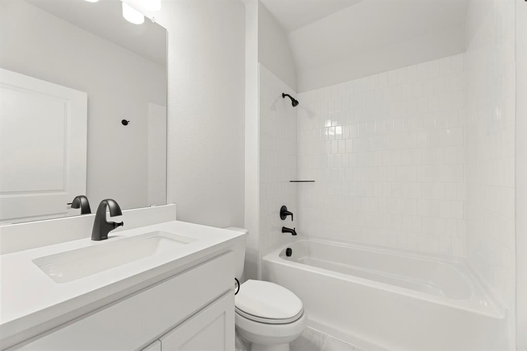 912 Firewood Way Anna, TX 75409 - Photo 23 of 29 a bathroom with a sink a toilet and shower