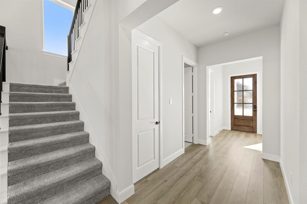 912 Firewood Way Anna, TX 75409 - Photo 3 of 29 a view of an entryway with wooden floor and stairs