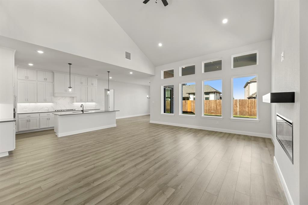 912 Firewood Way Anna, TX 75409 - Photo 7 of 29 a view of a kitchen with furniture and wooden floor