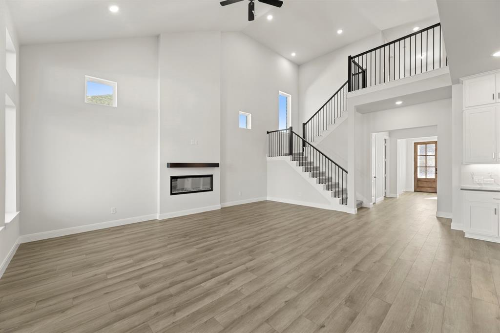 912 Firewood Way Anna, TX 75409 - Photo 8 of 29 a view of a livingroom with wooden floor and stairs