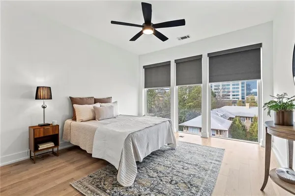 a bedroom with a large bed and a large window