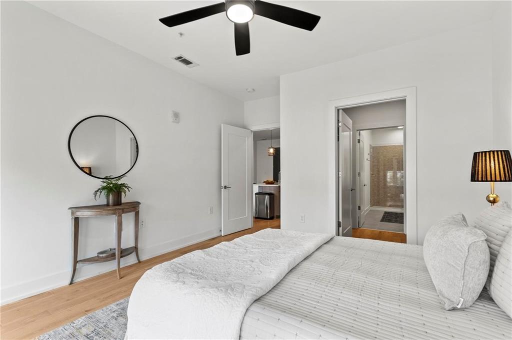 775 Juniper Street Northeast, Unit 613 Atlanta, GA 30308 - Photo 12 of 39 a bedroom with a bed and a chandelier