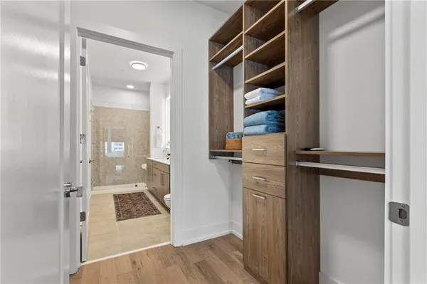 a view of walk in closet with empty racks