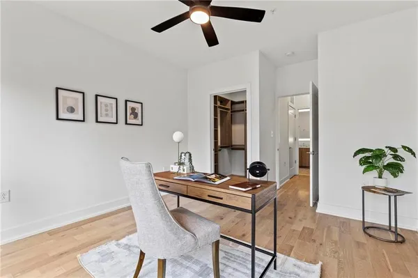 a view of a workspace with furniture and wooden floor
