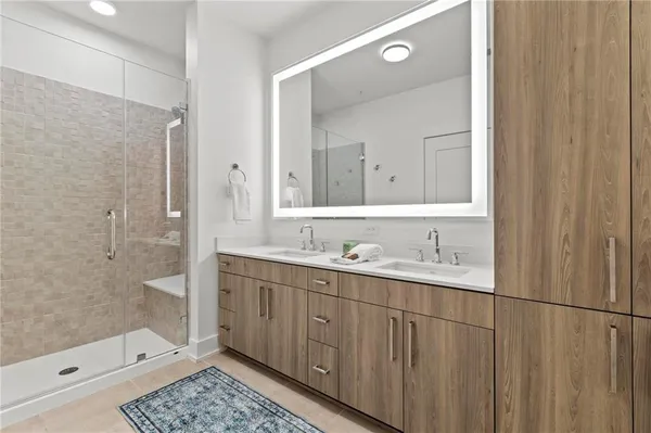 a bathroom with a shower sink and mirror