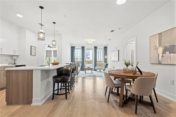 a view of a a dining room with furniture window and wooden floor