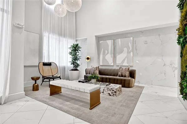 a living room with furniture and a chandelier