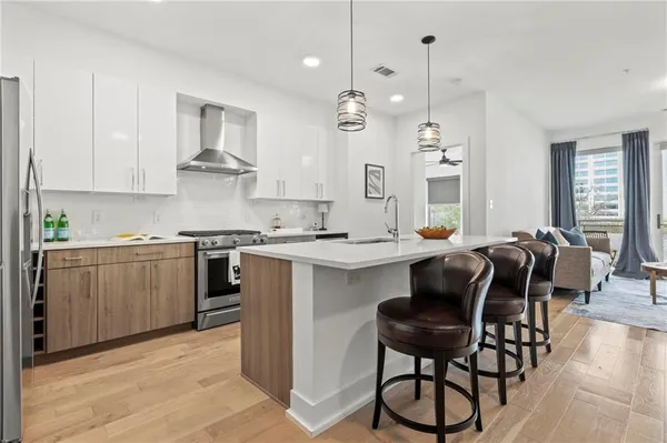 a kitchen with sink cabinets and stainless steel appliances